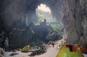 Members of an expedition have a meal at First Camp, the first level spot inside the cave entrance.